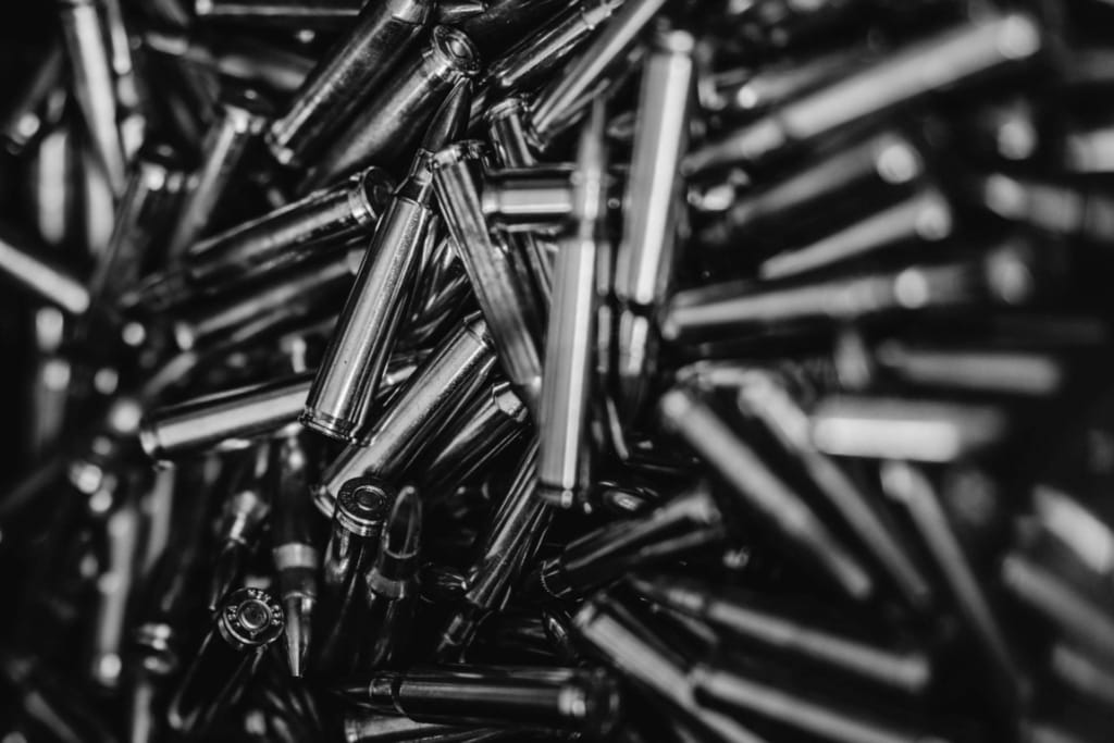 a pile of bullets in a black and white photo.